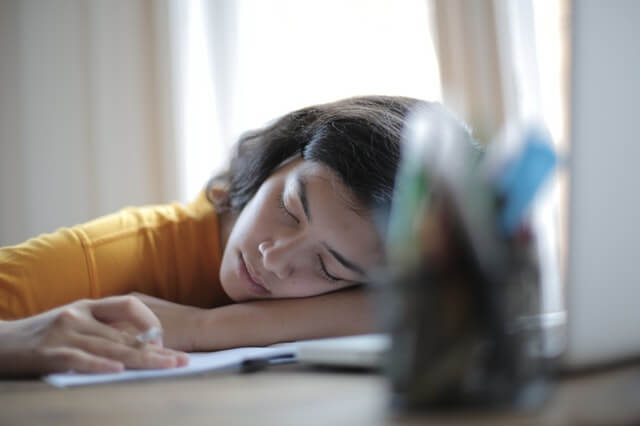 woman-in-yellow-shirt-resting-on-her-arm-3808017